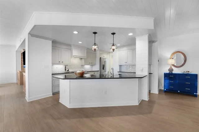 a large bathroom with a granite countertop double vanity sink and a mirror