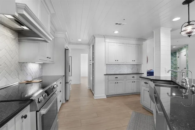 a kitchen with a sink stove and refrigerator