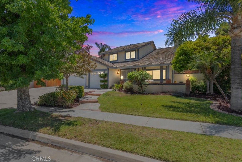 a front view of a house with a garden