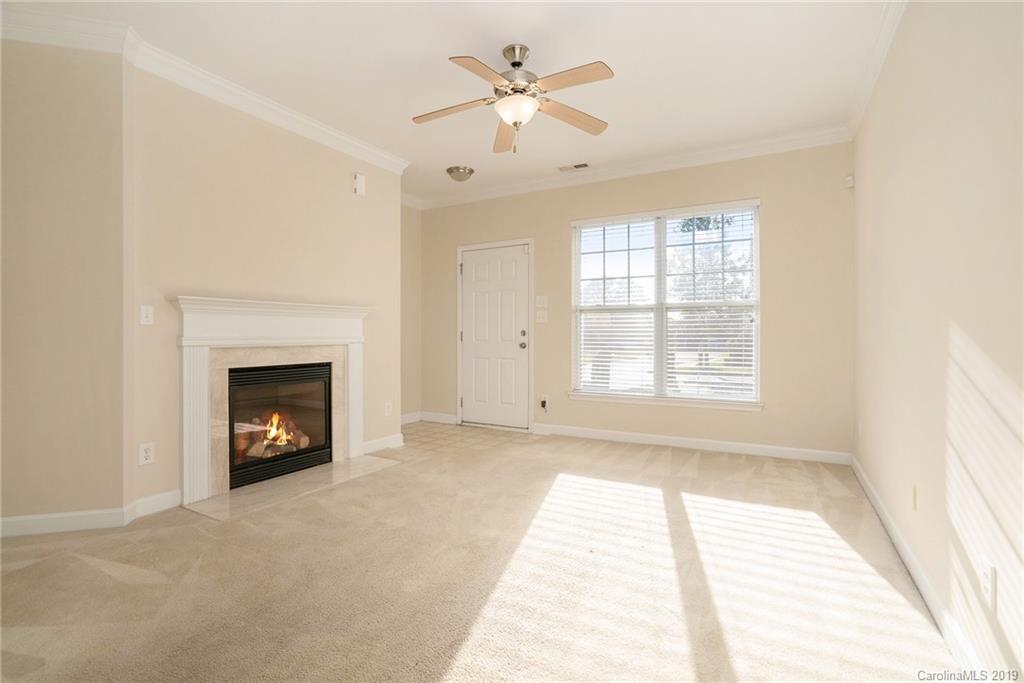 5132 Prosperity Church Road Charlotte, NC 28269 - Photo 2 of 32 a view of an empty room with window and a fireplace
