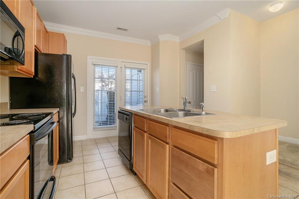 5132 Prosperity Church Road Charlotte, NC 28269 - Photo 13 of 32 a kitchen with a sink stove and refrigerator