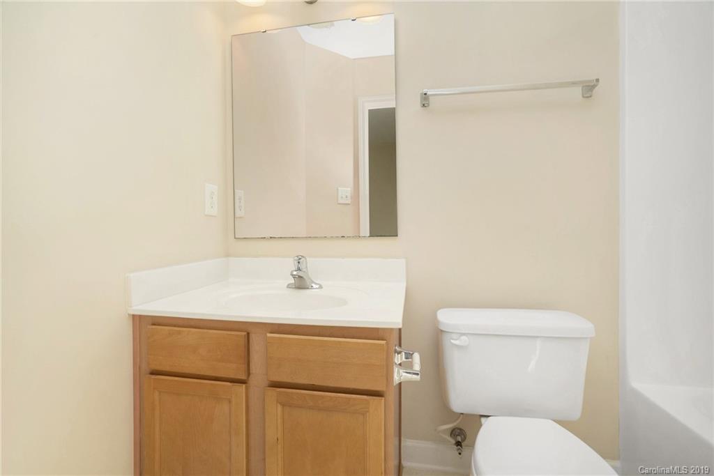 5132 Prosperity Church Road Charlotte, NC 28269 - Photo 21 of 32 a bathroom with a toilet sink vanity and mirror