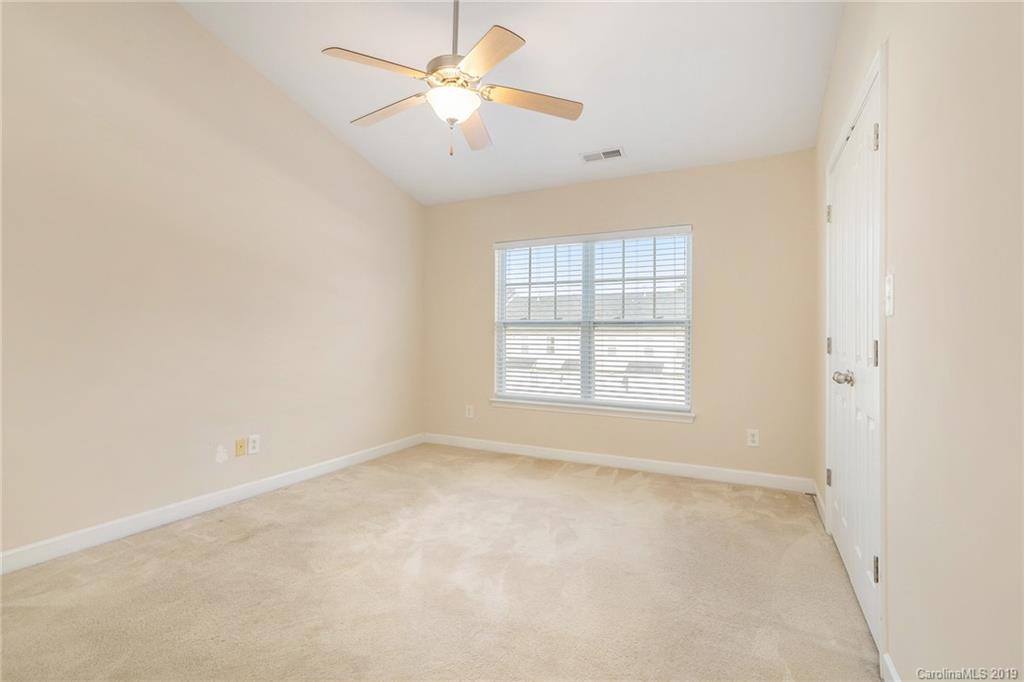 5132 Prosperity Church Road Charlotte, NC 28269 - Photo 22 of 32 an empty room with a window and a fan