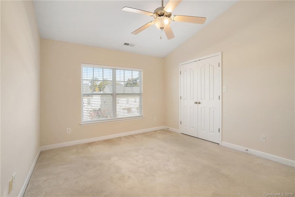 5132 Prosperity Church Road Charlotte, NC 28269 - Photo 23 of 32 an empty room with windows and fan