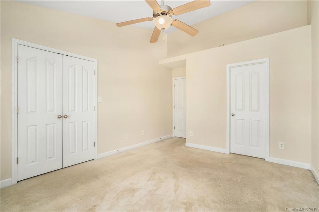 5132 Prosperity Church Road Charlotte, NC 28269 - Photo 24 of 32 an empty room with fan and entryway