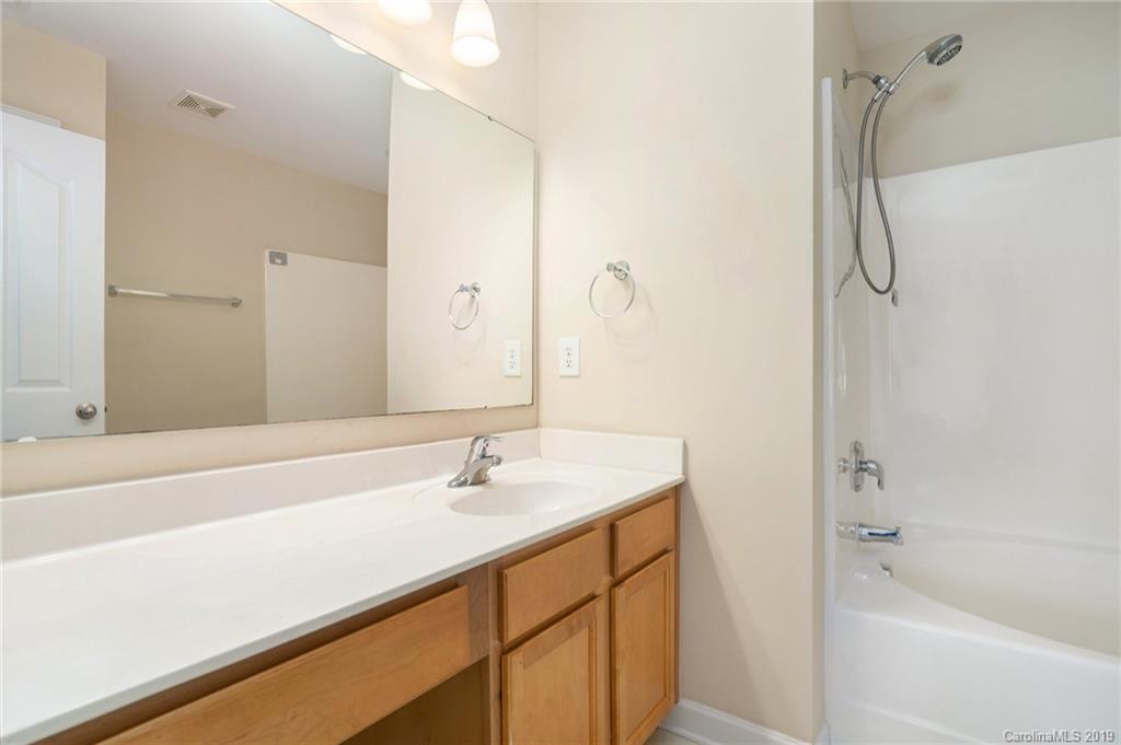 5132 Prosperity Church Road Charlotte, NC 28269 - Photo 26 of 32 a bathroom with a sink and a mirror