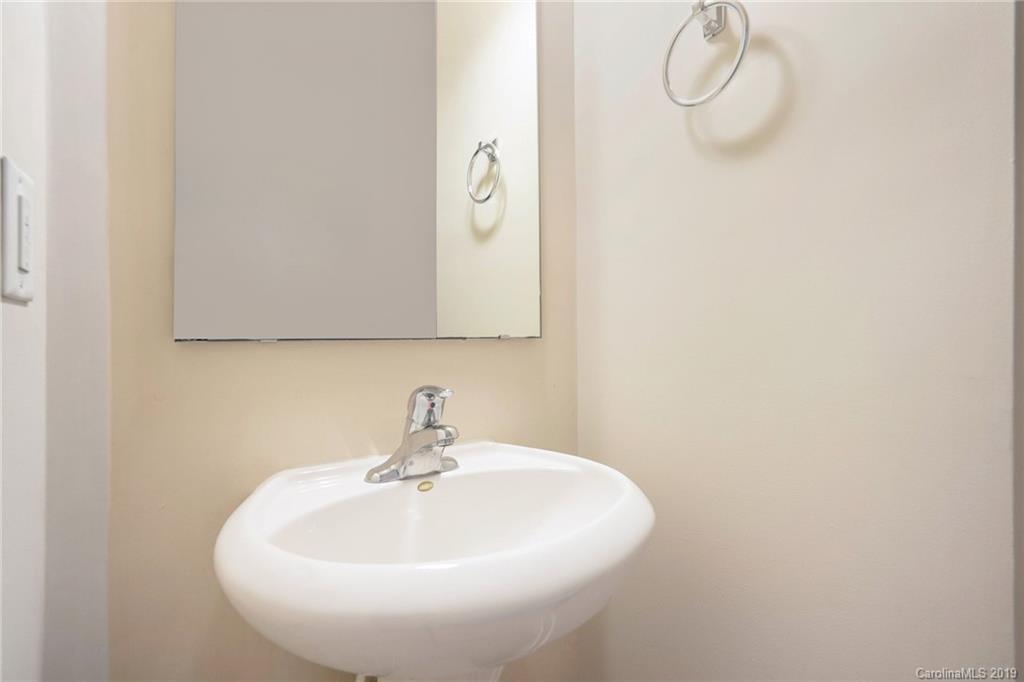 5132 Prosperity Church Road Charlotte, NC 28269 - Photo 28 of 32 a bathroom with a sink and mirror