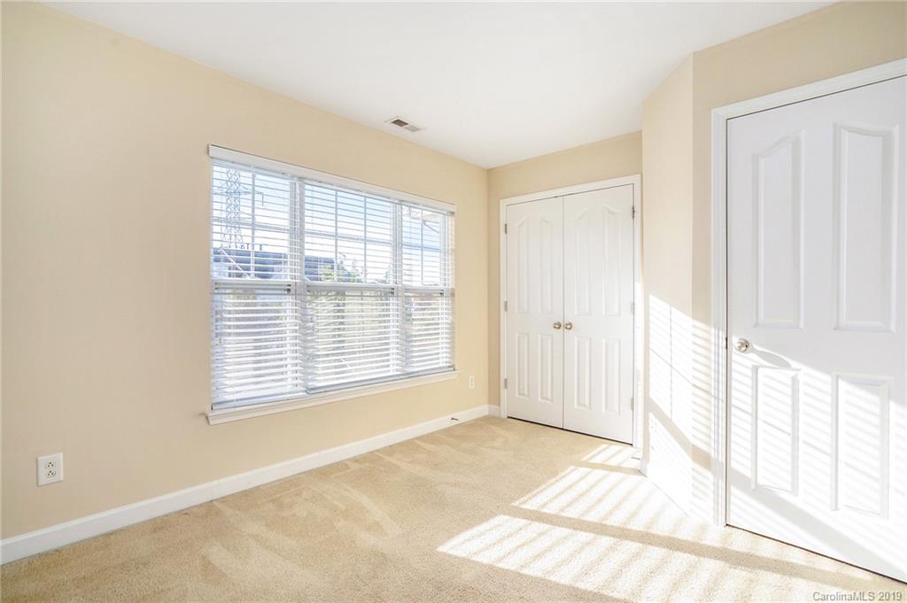 5132 Prosperity Church Road Charlotte, NC 28269 - Photo 7 of 32 a view of an empty room with a window