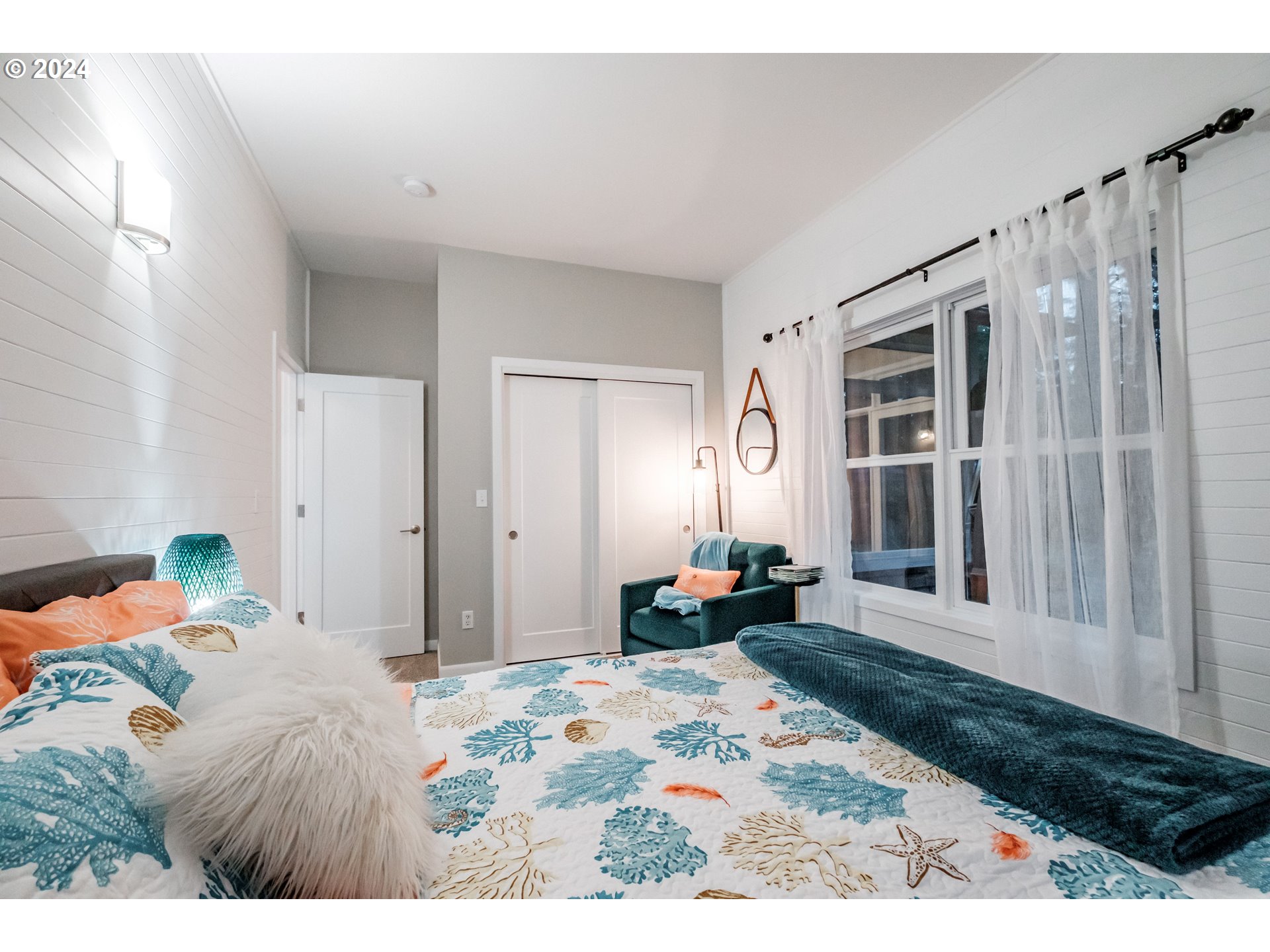 9350 Whiskey Creek Road Tillamook, OR 97141 - Photo 24 of 32 a bed room with a bed window and a couch