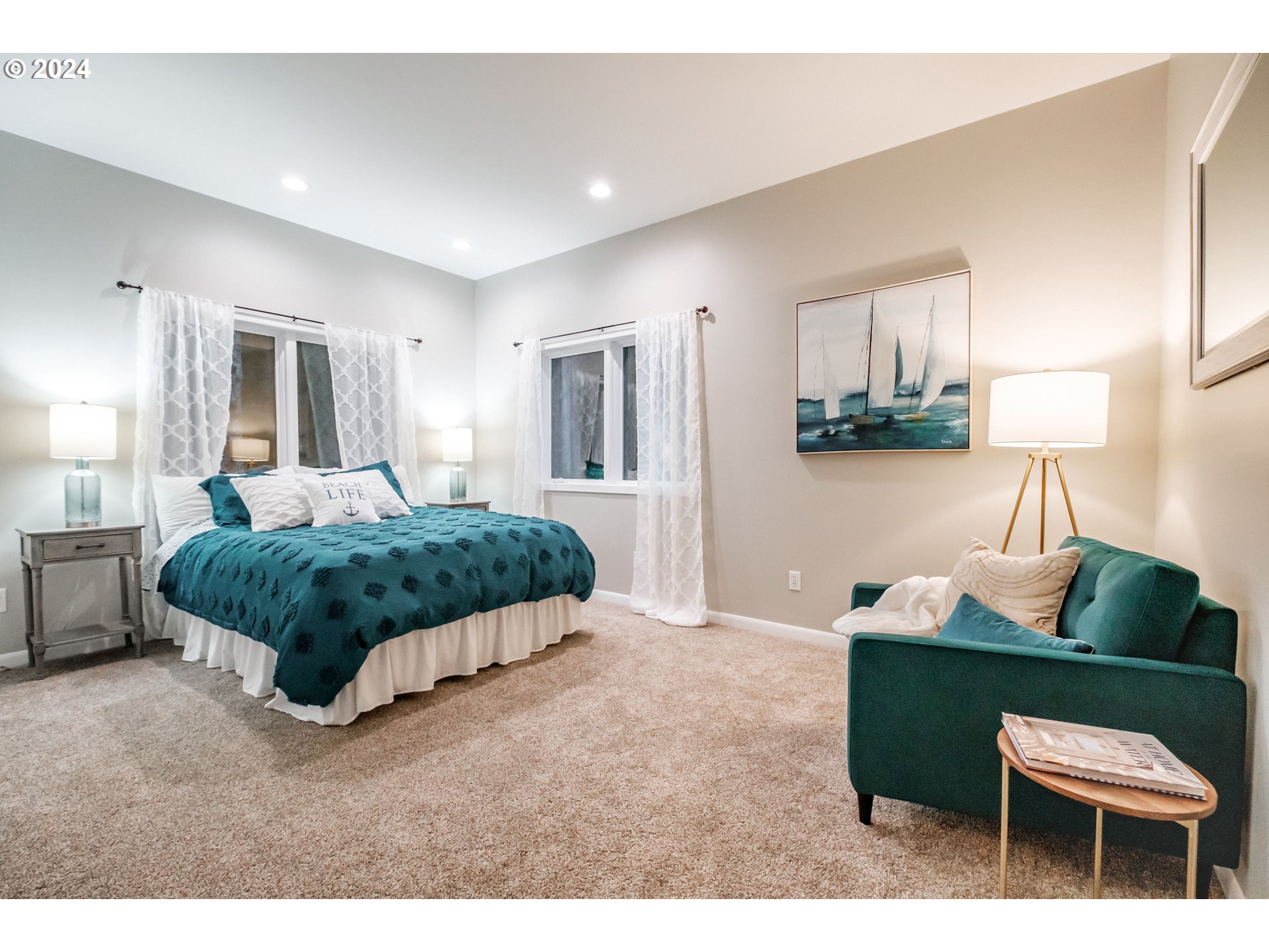 9350 Whiskey Creek Road Tillamook, OR 97141 - Photo 26 of 32 a spacious bedroom with a bed and a couch