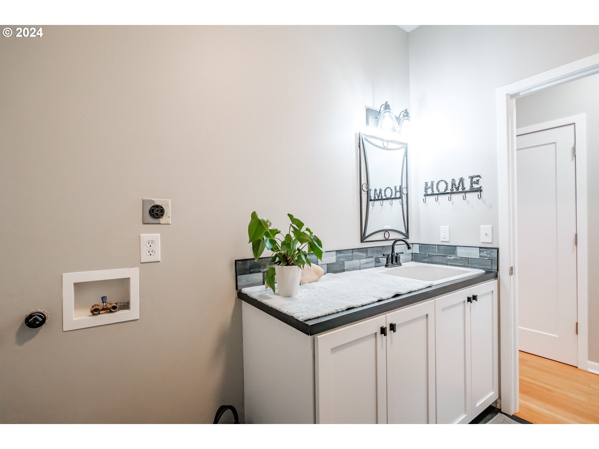 9350 Whiskey Creek Road Tillamook, OR 97141 - Photo 28 of 32 a bathroom with a sink and a mirror