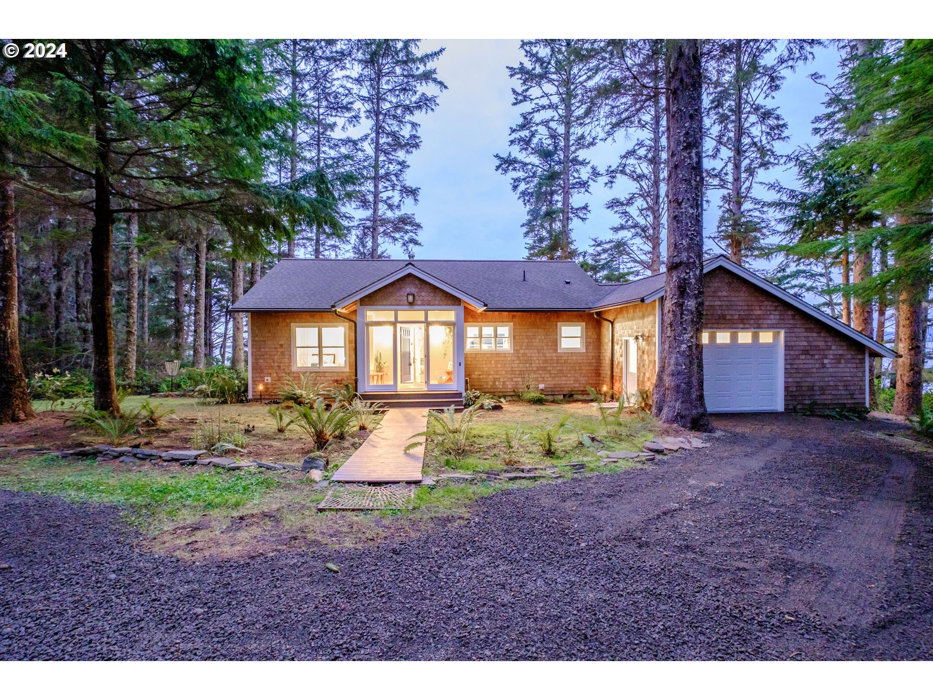 9350 Whiskey Creek Road Tillamook, OR 97141 - Photo 29 of 32 a view of a house with a yard and tree s