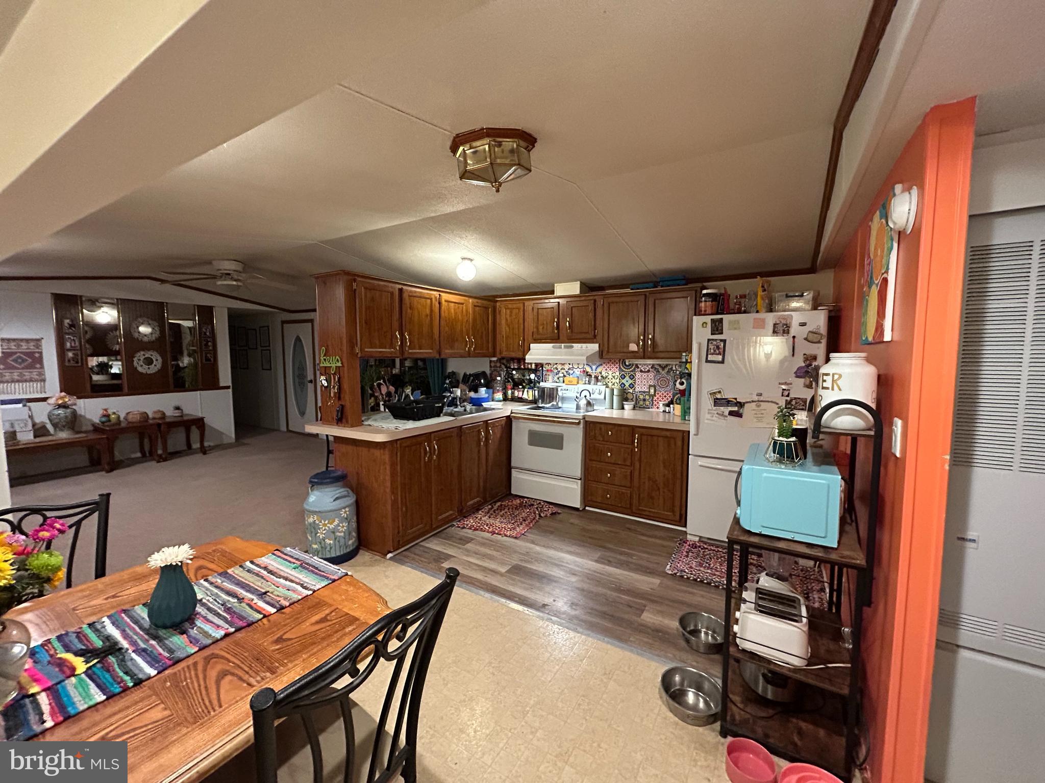 90 Knight Road, Unit L22 Gettysburg, PA 17325 - Photo 5 of 14 a kitchen with a refrigerator and a dining table