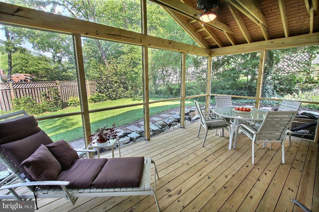 12902 Goodhill Road Silver Spring, MD 20906 - Photo 5 of 20 a view of a porch with furniture and wooden floor