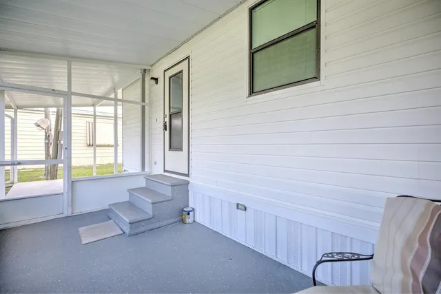 a view of an empty room with a floor to ceiling window