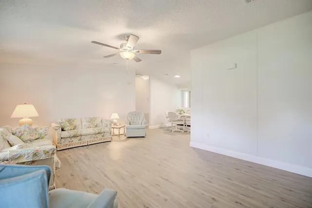 a view of living room with furniture and a chandelier