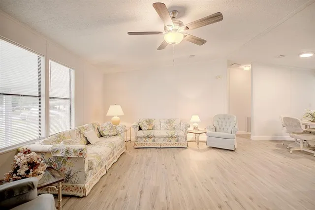 a bedroom with furniture and a large window