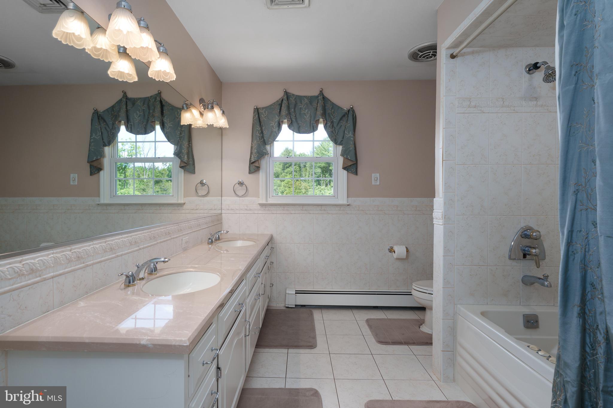 56 Valley Road Lambertville, NJ 08530 - Photo 32 of 49 a bathroom with a double vanity sink and a bathtub