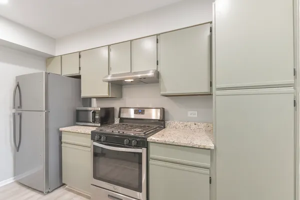 a kitchen with stainless steel appliances granite countertop white refrigerator stove a sink and dishwasher