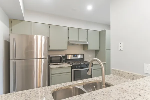 a kitchen with a refrigerator sink and stainless steel appliances