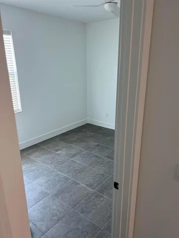 a kitchen with a sink a refrigerator a stove and white cabinets