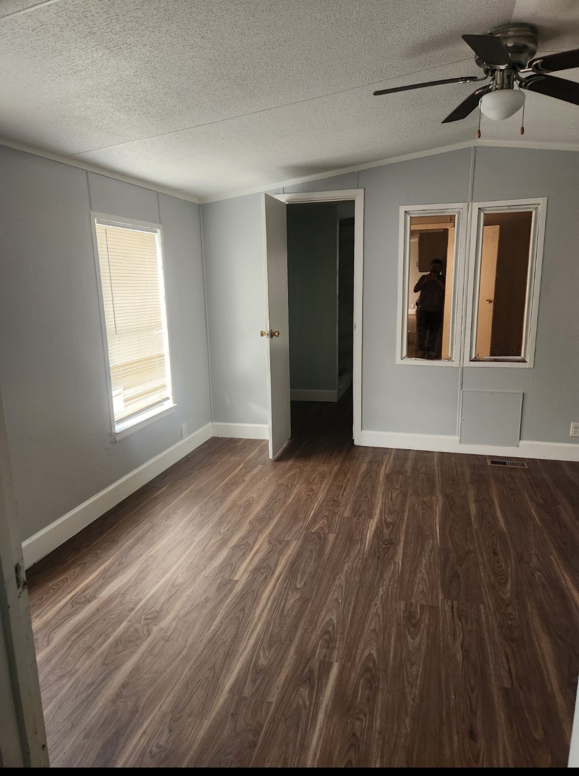 3614 Cedar Street, Unit C264R Damon, TX 77430 - Photo 3 of 7 a view of an empty room with wooden floor and a window