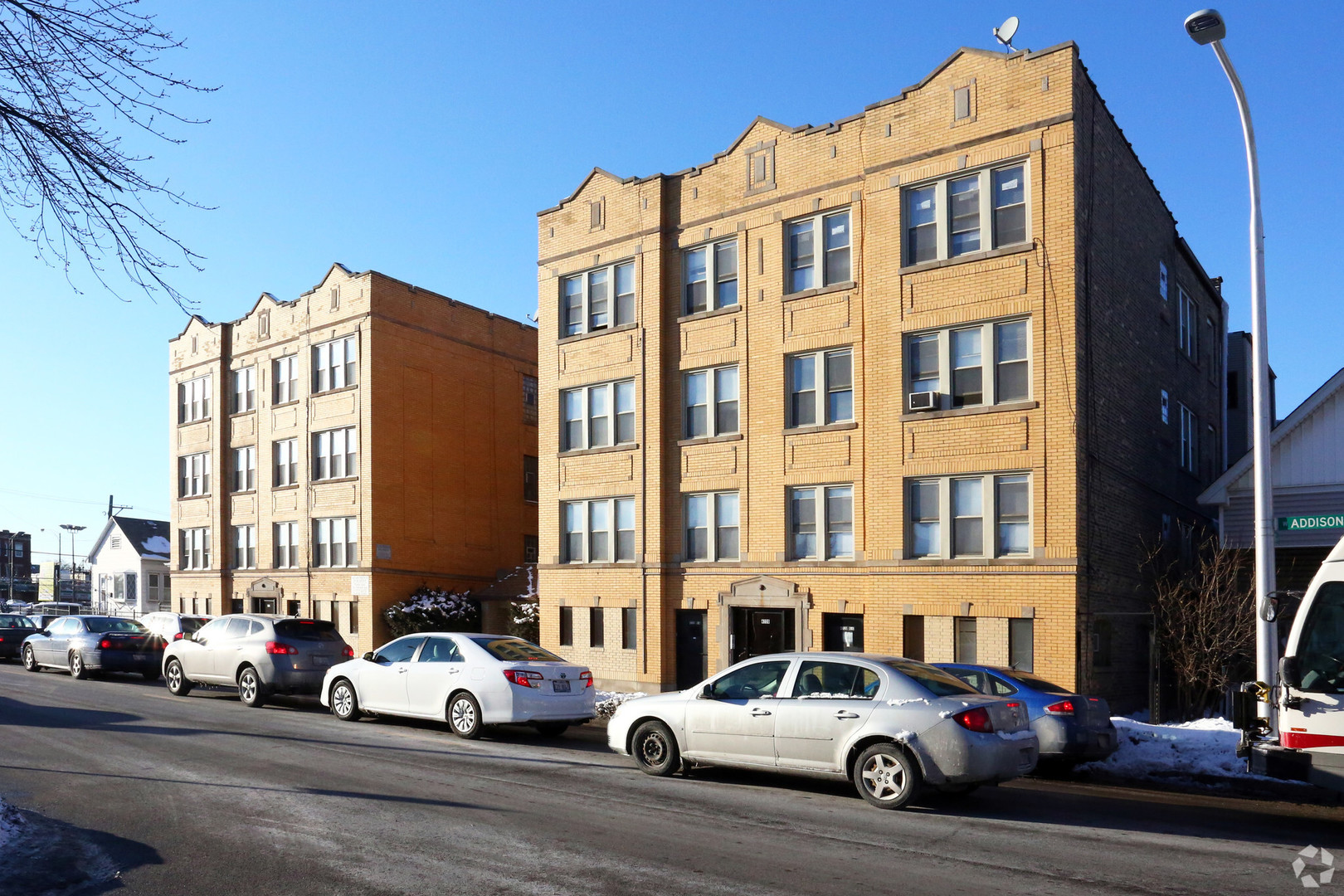4728 West Addison Street Chicago, IL 60641 - Photo 10 of 10 a buildings and cars parked in front of a building