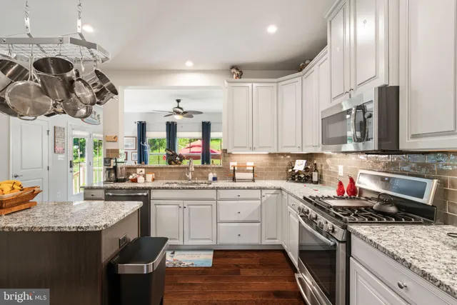 a kitchen with kitchen island a sink stove and refrigerator