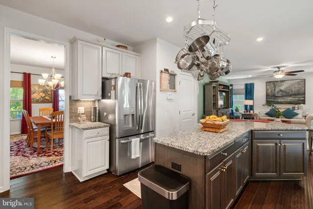 a living room with furniture a large window and a fireplace