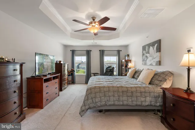 a bathroom with a granite countertop double vanity sink a mirror and a bathtub