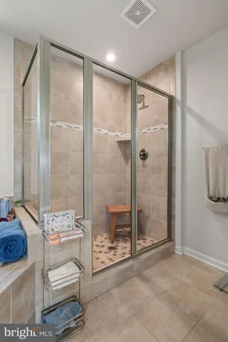 a bedroom with a bed window and dresser