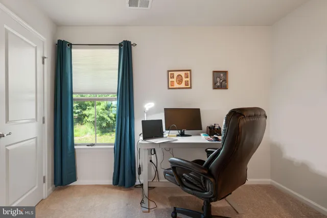 a work room with furniture lamp gym equipment and a window