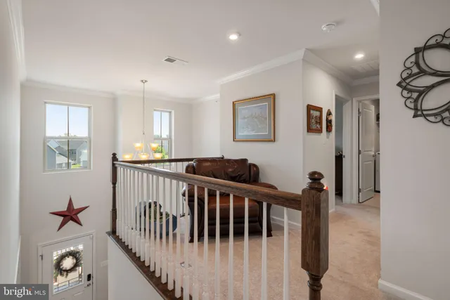 a view of a living room with furniture and wooden floor