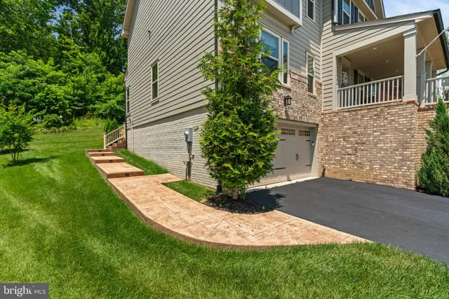 an aerial view of a house with a yard and trees