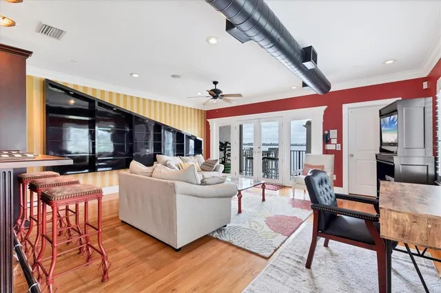 a living room with furniture ceiling fan and a rug