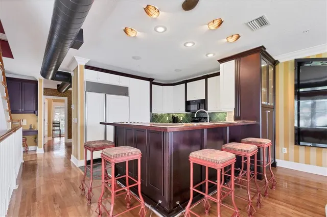 a view of a dining room with furniture wooden floor and chandelier