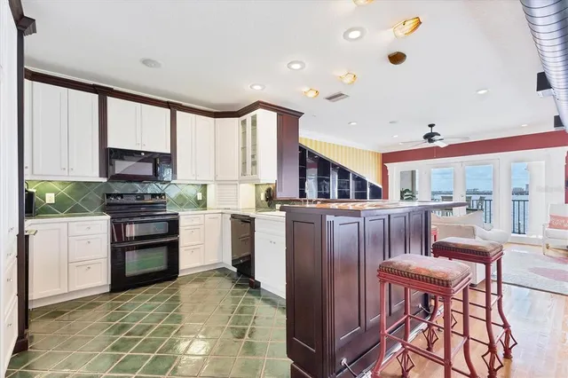 a view of a dining room with furniture and a chandelier