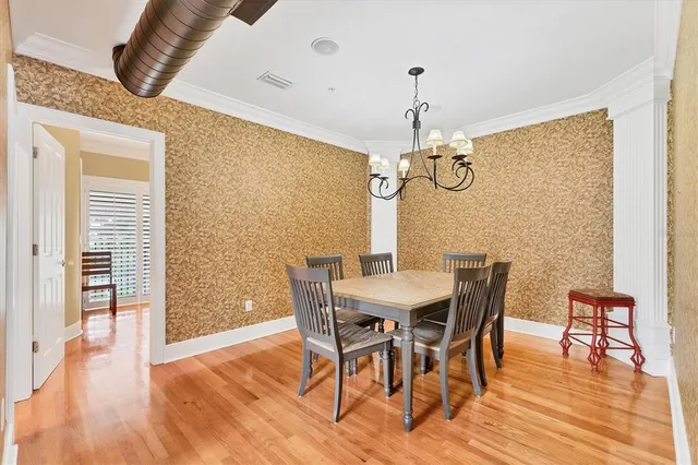 a view of a hallway with wooden floor and windows