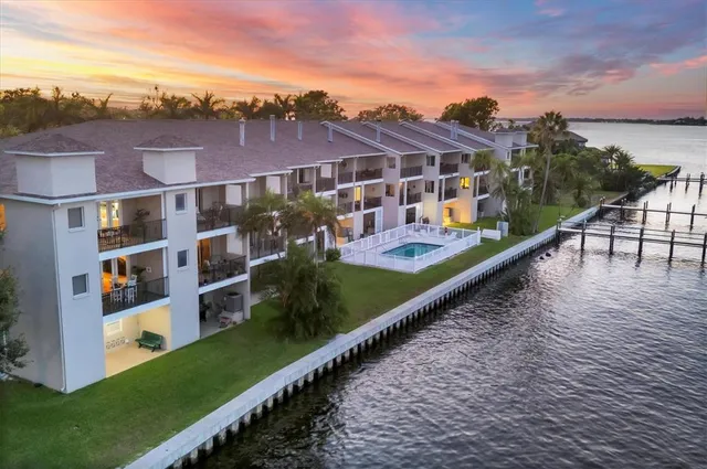 a view of building with yard and lake view