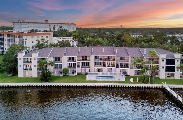an aerial view of residential houses with outdoor space and river