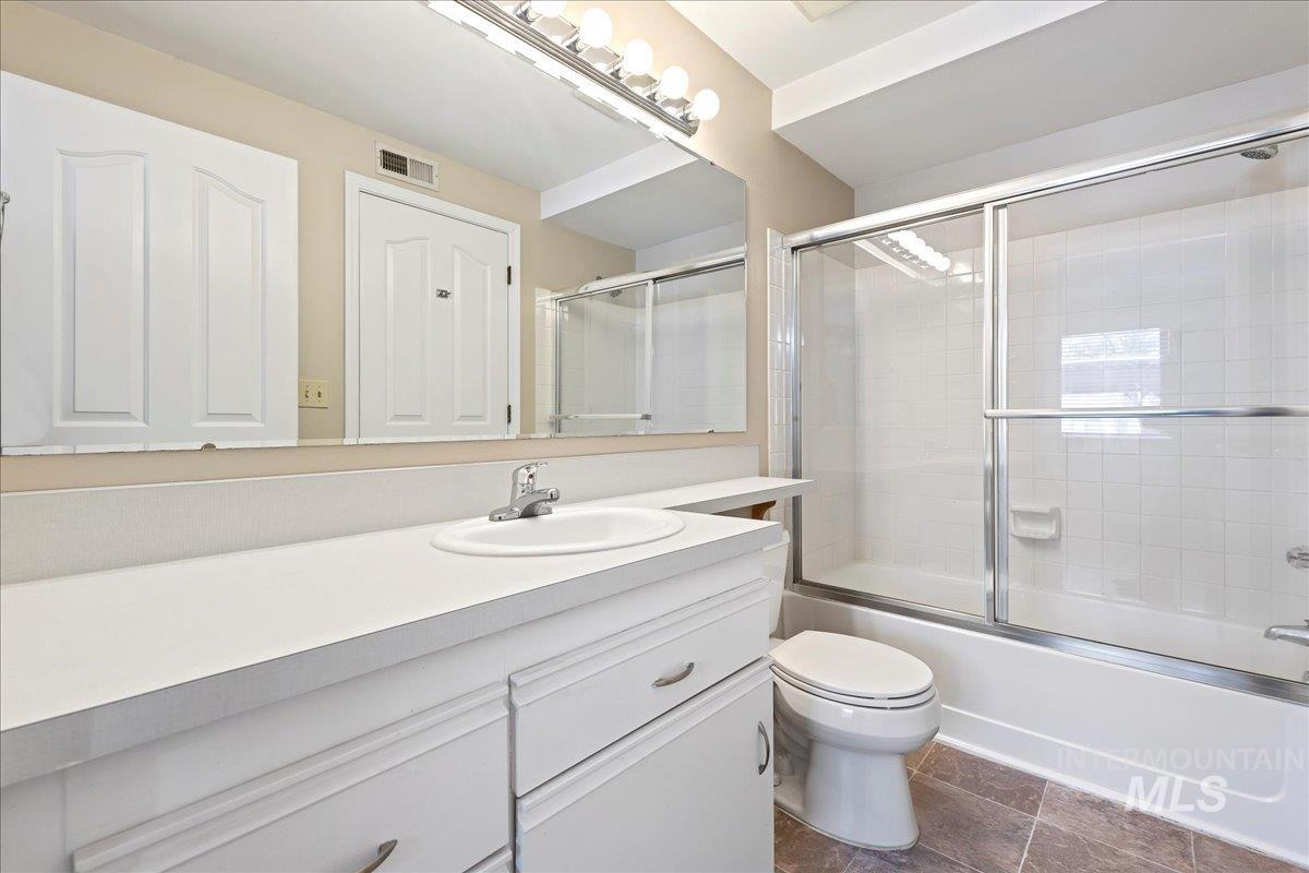 3611 South Gekeler Lane, Unit 124 Boise, ID 83706 - Photo 13 of 27 Full bathroom featuring vanity and combined bath / shower with glass door