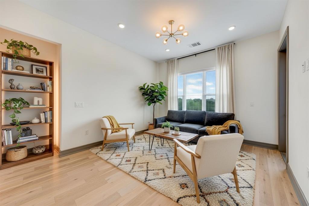 a living room with furniture and wooden floor