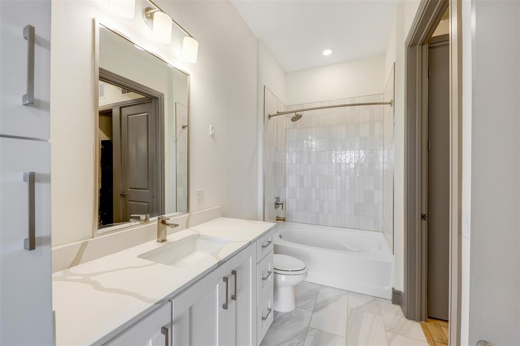2700 Old Denton Road, Unit 2236 Carrollton, TX 75007 - Photo 15 of 23 a bathroom with a sink a toilet and shower