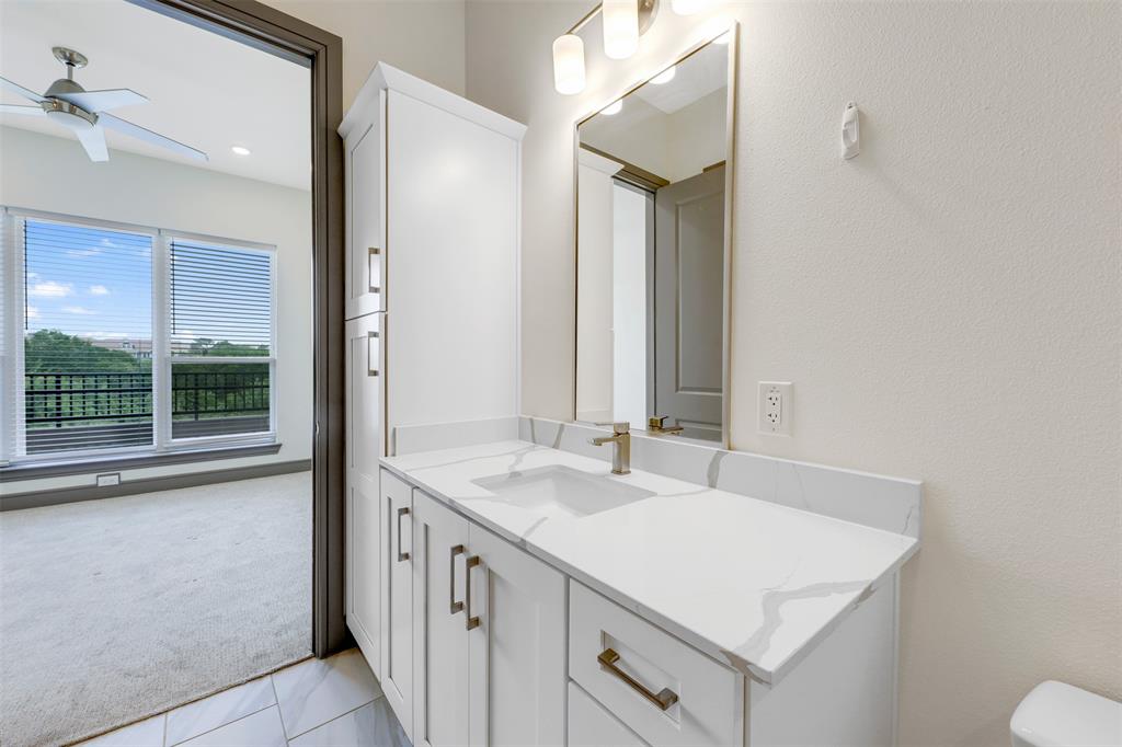 2700 Old Denton Road, Unit 2236 Carrollton, TX 75007 - Photo 18 of 23 a bathroom with a sink vanity granite and a mirror