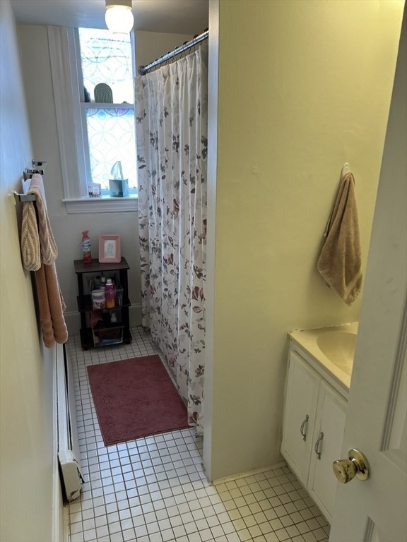137 Peterborough Street, Unit 31 Boston, MA 02215 - Photo 6 of 14 a bathroom with a sink a toilet a window and vanity