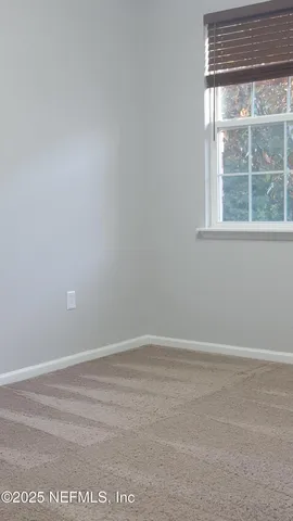 a kitchen with large cabinets and wooden floor