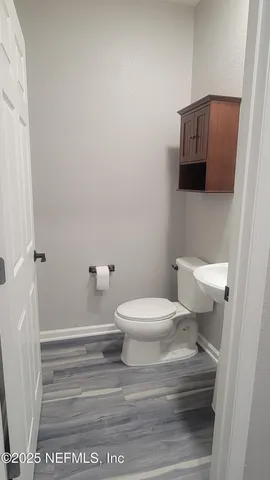 a room with a walk in closet and a mirror