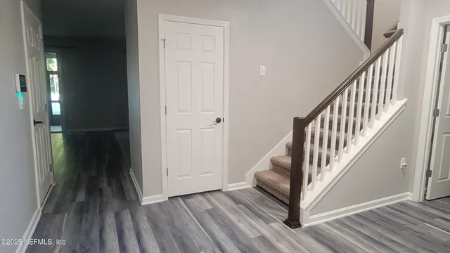a view of walk in closet with empty racks