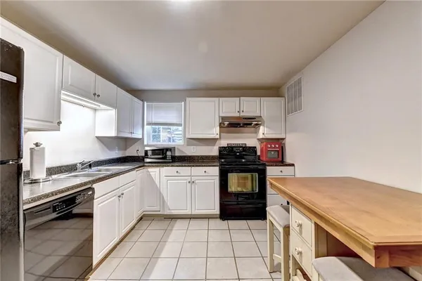 a kitchen with stainless steel appliances cabinets and a refrigerator