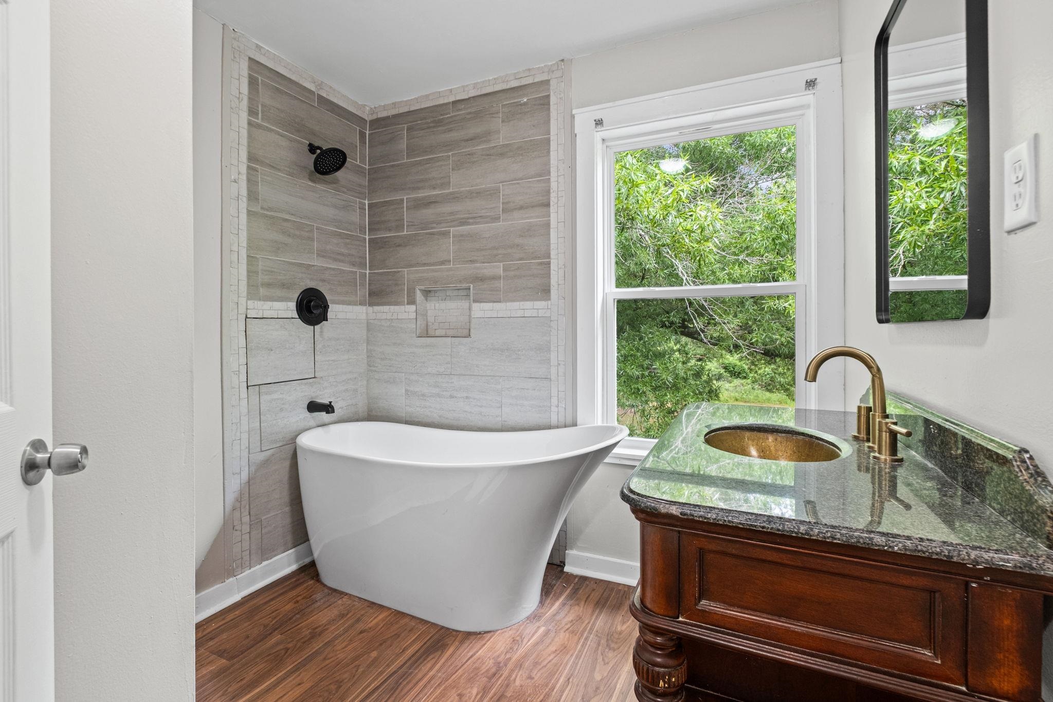 5843 Stewart Road Lakeland, TN 38002 - Photo 23 of 26 Freestanding soaking tub with dark bronze fixtures and tiled surround